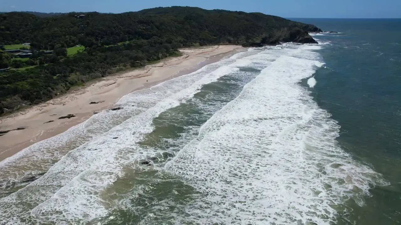 Aerial view of an Australian coastline with surf breaking along a long beach