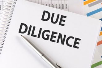 Due diligence paperwork and a pen represent a financial review within the vet sector.